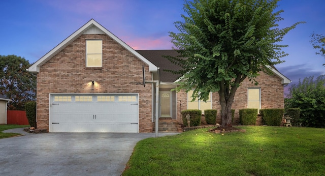 front facade with a yard and a garage