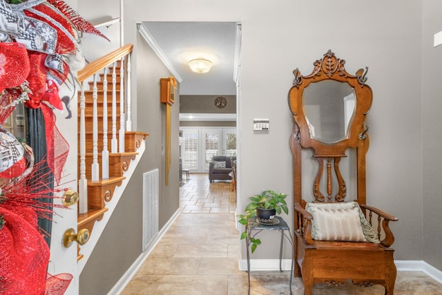 hall with crown molding, french doors, and light tile patterned floors