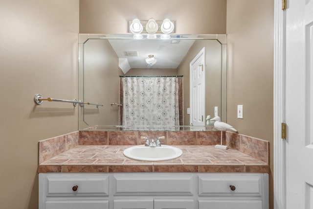 bathroom featuring a shower with curtain and vanity