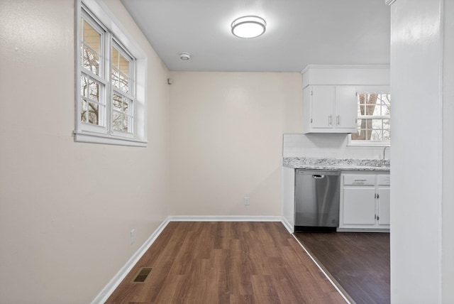 kitchen with white cabinets, stainless steel dishwasher, dark wood-type flooring, and sink