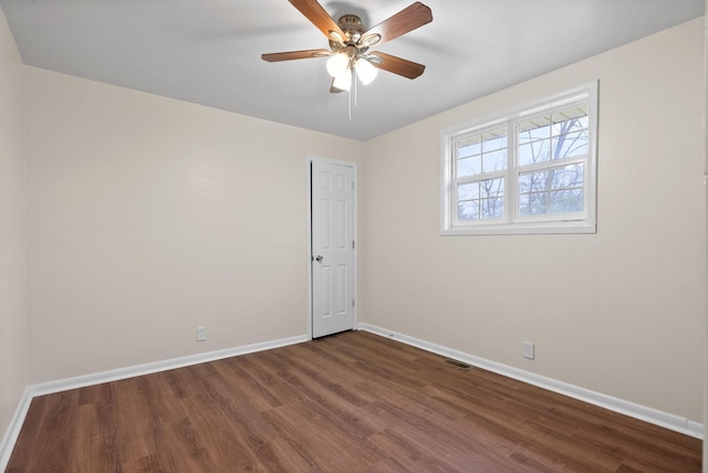 unfurnished room featuring ceiling fan and dark wood-type flooring