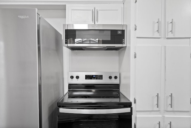 kitchen with white cabinets and appliances with stainless steel finishes