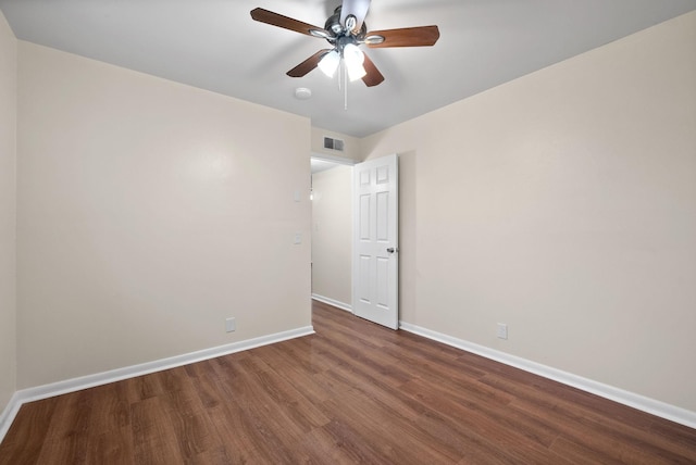 unfurnished room with ceiling fan and dark wood-type flooring