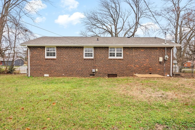 rear view of house with a yard