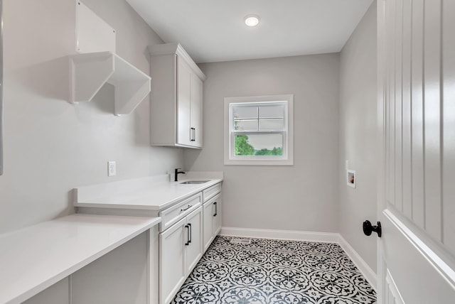 laundry room with washer hookup, cabinets, and sink