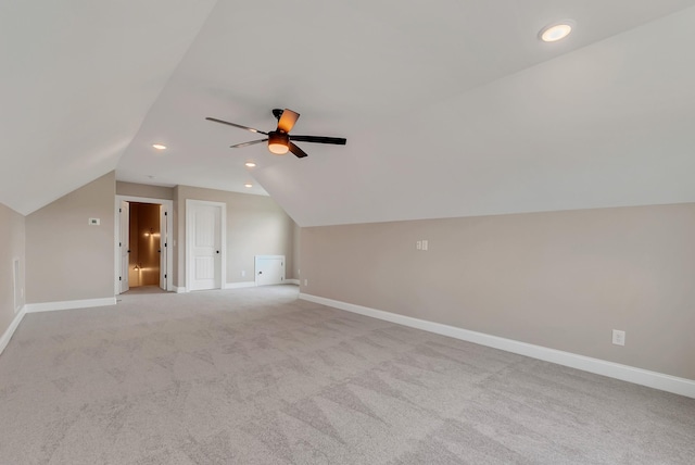 bonus room featuring ceiling fan, lofted ceiling, and light carpet