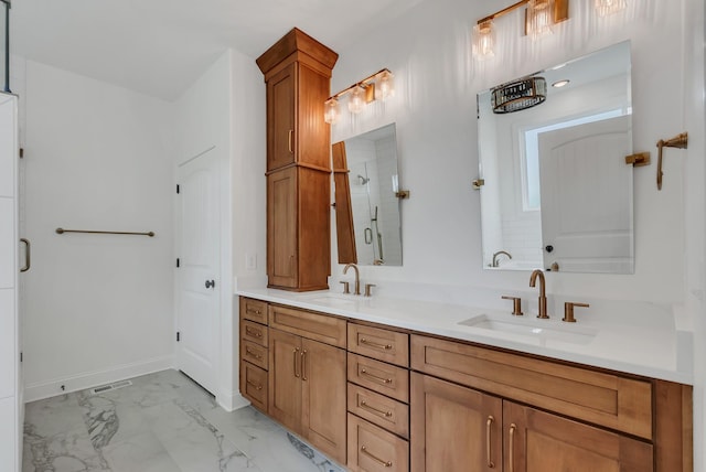 bathroom featuring a shower with door and vanity