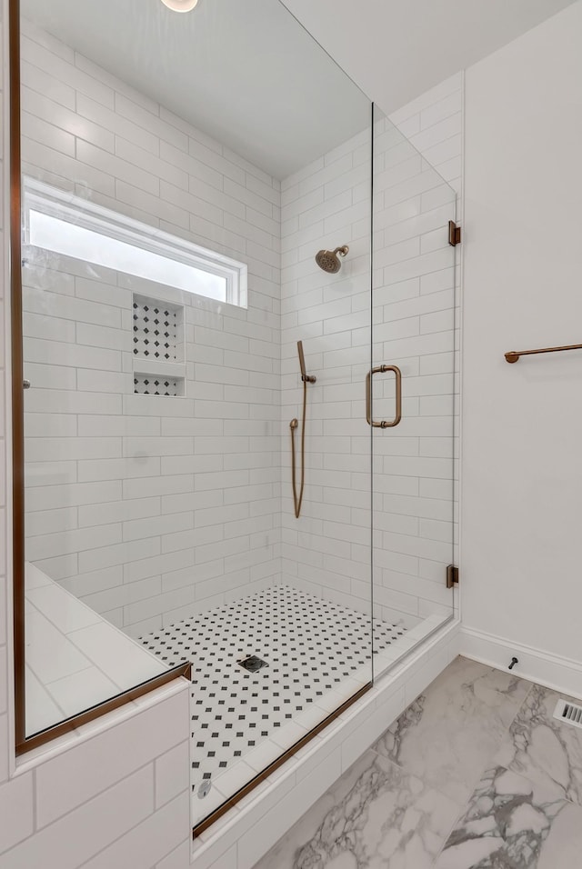 bathroom featuring a shower with door