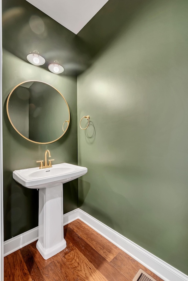 bathroom with wood-type flooring