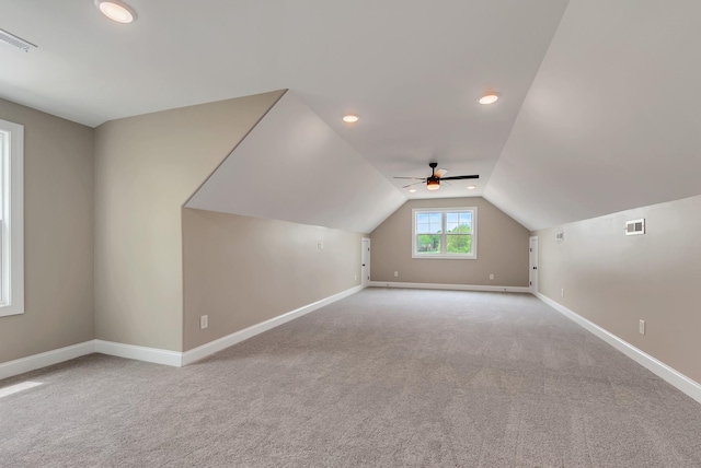 bonus room featuring light carpet, ceiling fan, and lofted ceiling