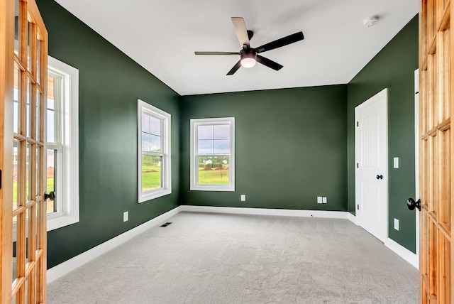 carpeted empty room with ceiling fan