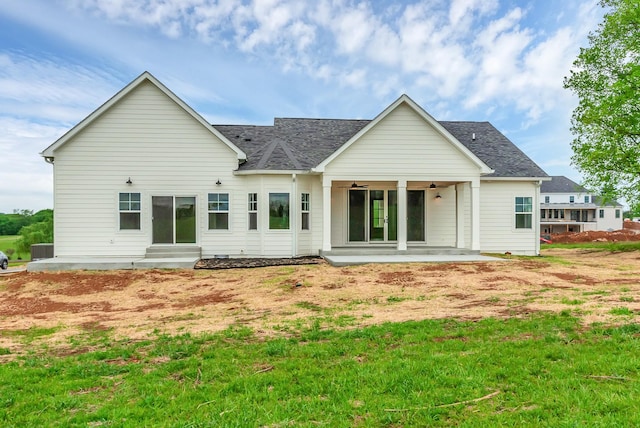 back of house with ceiling fan and a patio