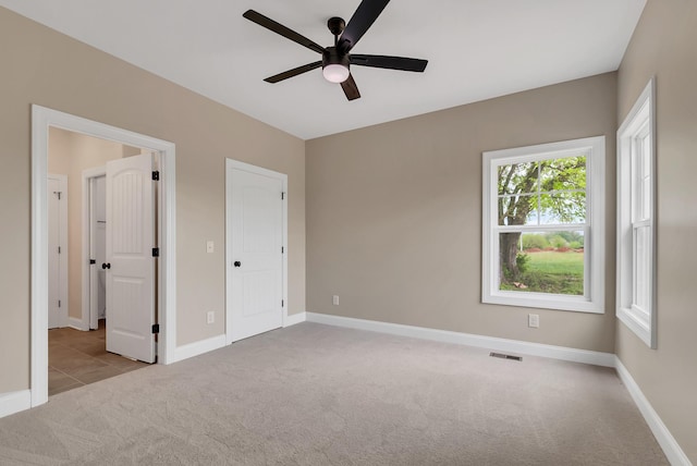 unfurnished bedroom with ceiling fan and light carpet