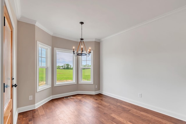 unfurnished room with a chandelier, ornamental molding, and wood-type flooring