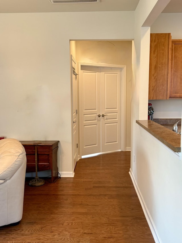 hall with dark wood-type flooring