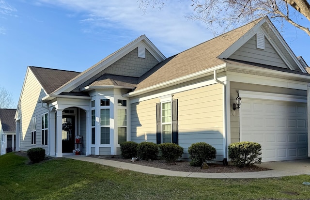 view of front facade with a garage and a front lawn