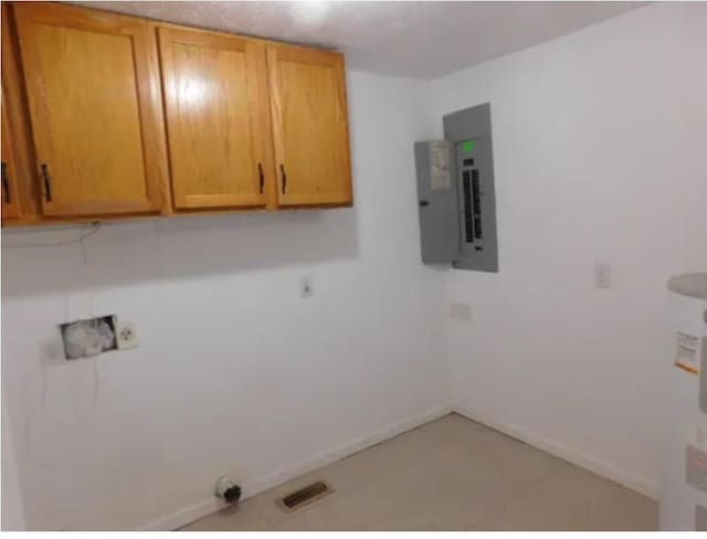 washroom featuring cabinets and electric panel