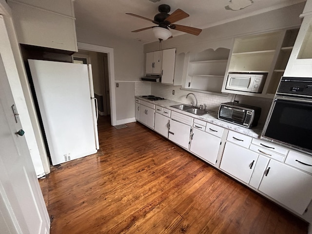 kitchen with white cabinets, white appliances, and sink