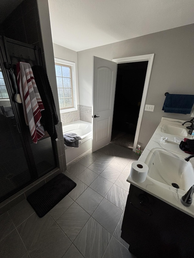 bathroom featuring separate shower and tub, tile patterned floors, and vanity