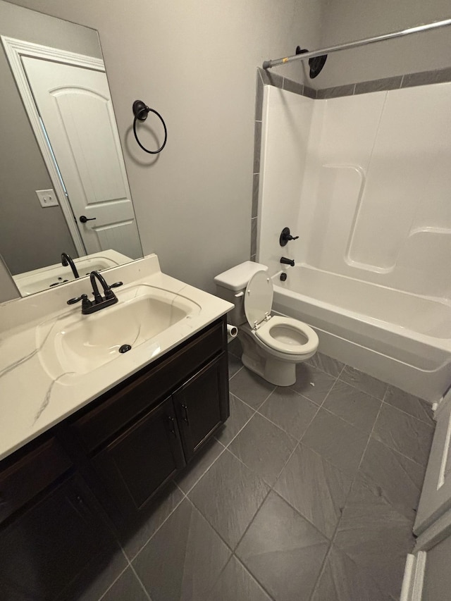 full bathroom with tile patterned floors, shower / bathing tub combination, vanity, and toilet