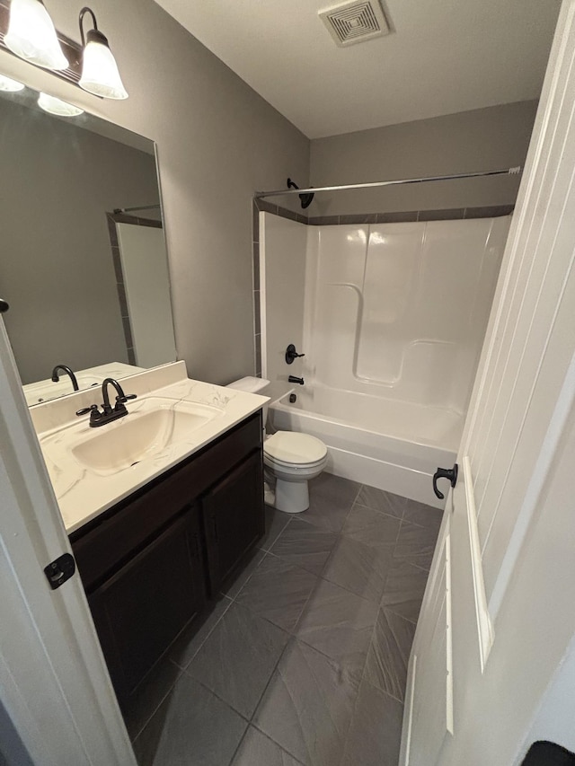 full bathroom featuring toilet, tile patterned flooring, vanity, and washtub / shower combination