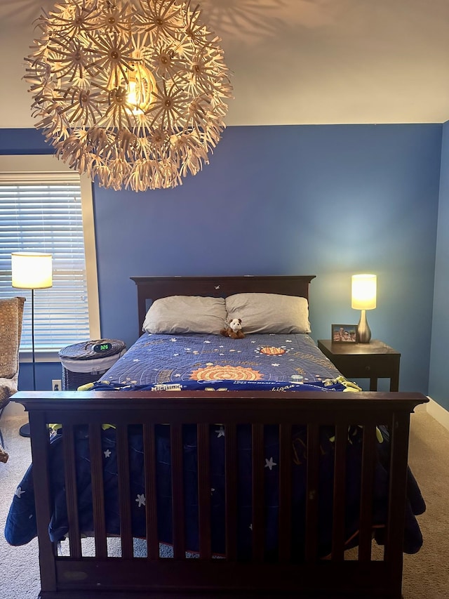 bedroom with carpet and a notable chandelier