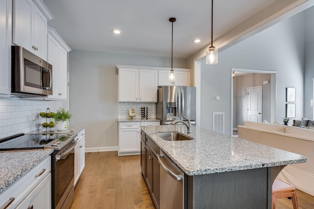 kitchen with white cabinetry, sink, and appliances with stainless steel finishes