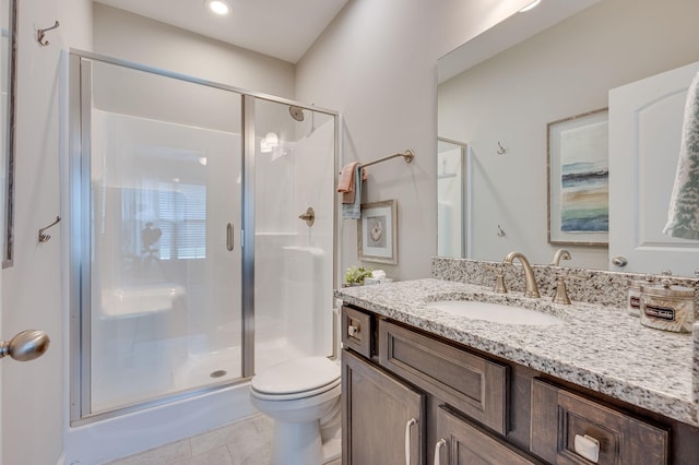 bathroom with tile patterned floors, vanity, toilet, and an enclosed shower