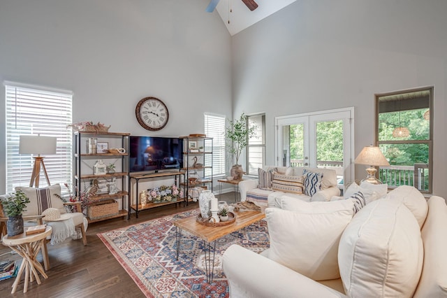 living room featuring dark wood-type flooring, high vaulted ceiling, ceiling fan, and a healthy amount of sunlight