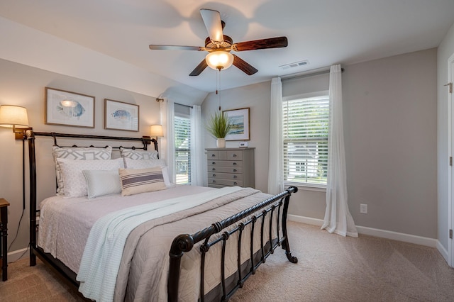 carpeted bedroom featuring ceiling fan, lofted ceiling, and multiple windows