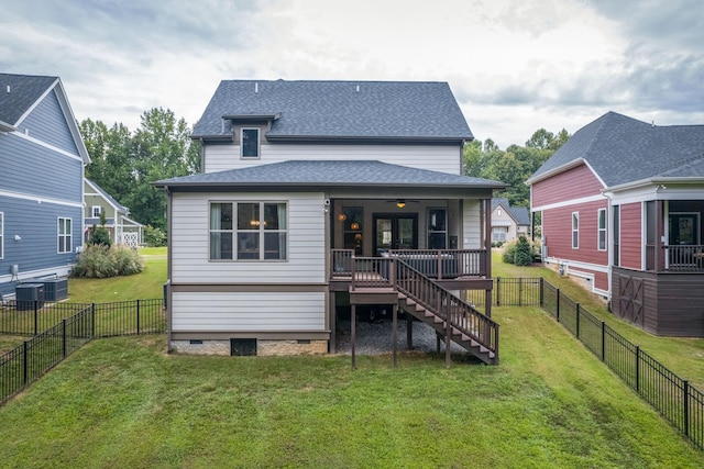 rear view of property with a yard and a wooden deck