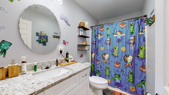 bathroom featuring walk in shower, tile patterned floors, vanity, and toilet