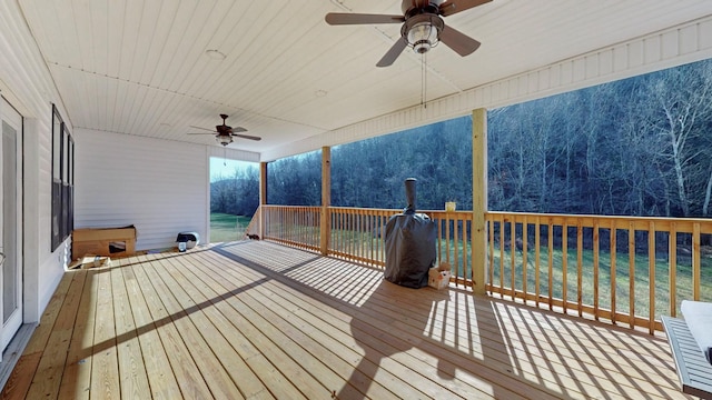 wooden deck featuring ceiling fan