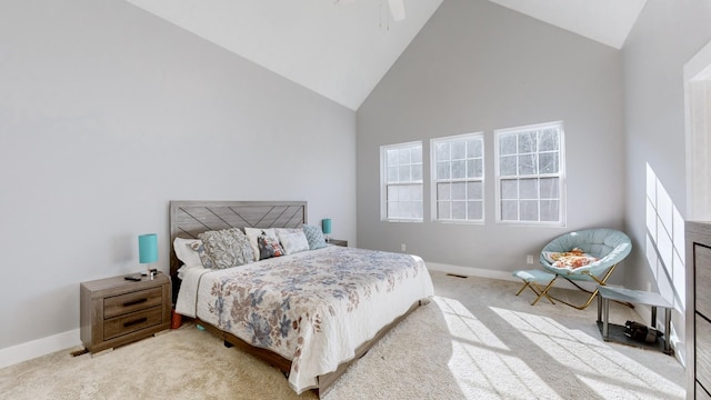 bedroom featuring ceiling fan, high vaulted ceiling, and light colored carpet