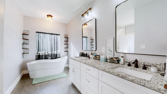 bathroom with tile patterned flooring, vanity, and a tub to relax in