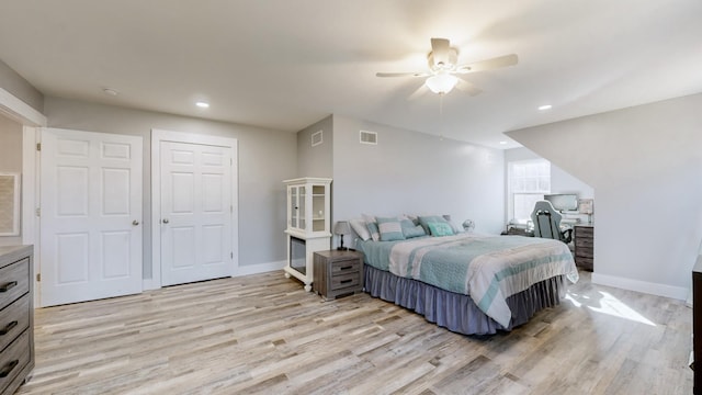 bedroom with light hardwood / wood-style floors and ceiling fan