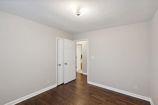 spare room with dark hardwood / wood-style floors