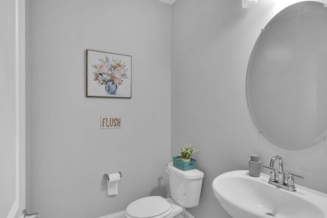 bathroom featuring toilet and sink