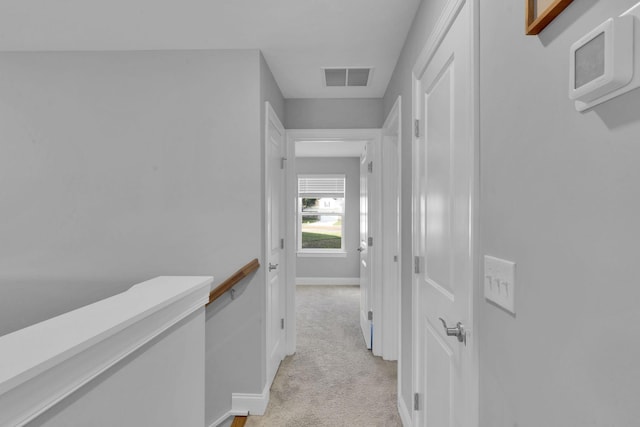 hallway with light colored carpet