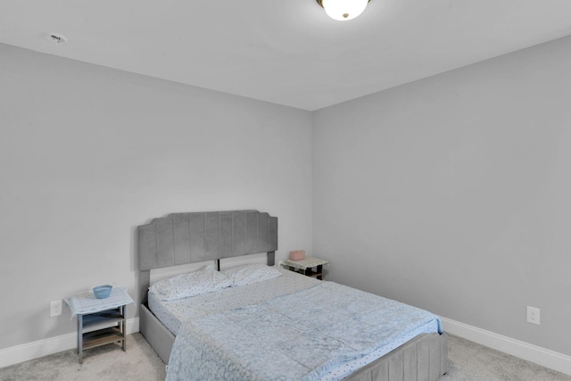 bedroom featuring light colored carpet