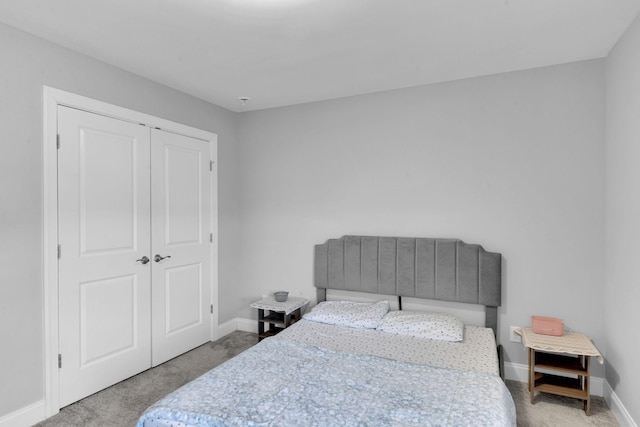 bedroom with light carpet and a closet