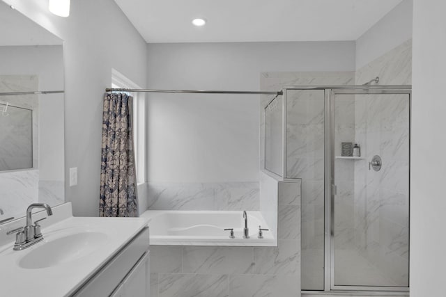 bathroom featuring plus walk in shower and vanity