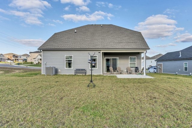 back of house featuring a lawn, central AC unit, and a patio