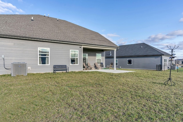 rear view of property with a patio, central AC unit, and a lawn