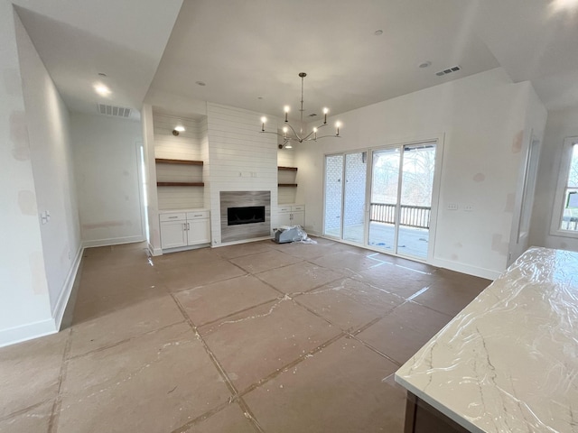 unfurnished living room with a fireplace and a chandelier