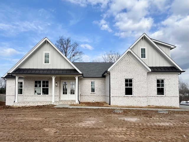 view of front of house with covered porch and french doors