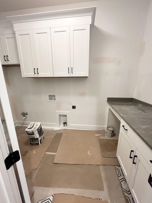 clothes washing area featuring hookup for a washing machine, cabinets, and hookup for an electric dryer