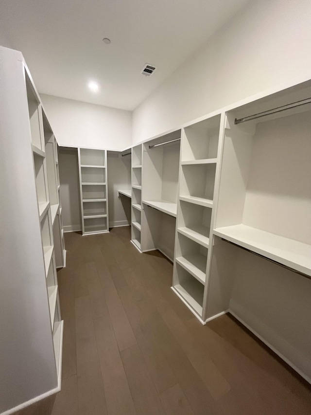 walk in closet with dark wood-style floors and visible vents