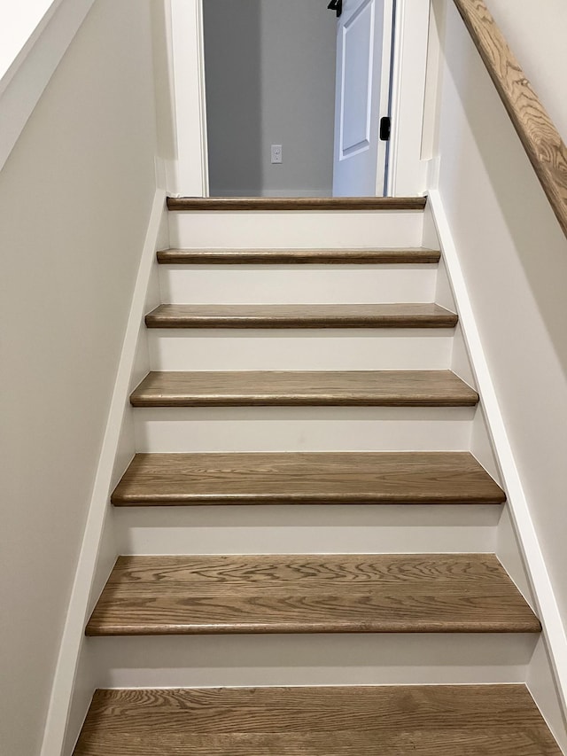 staircase featuring wood finished floors