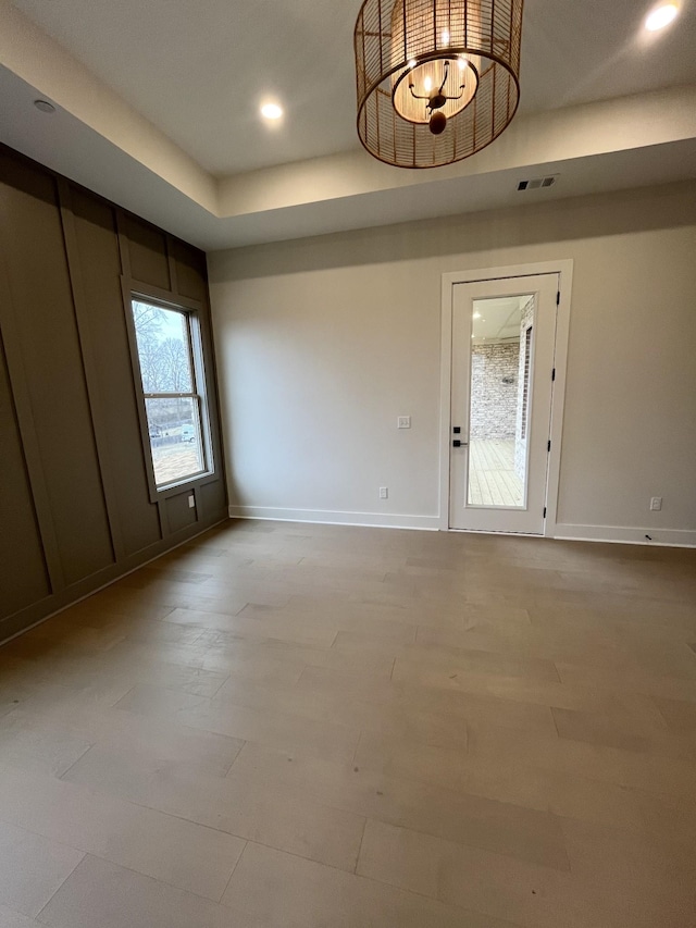 empty room with light wood-type flooring, baseboards, visible vents, and recessed lighting